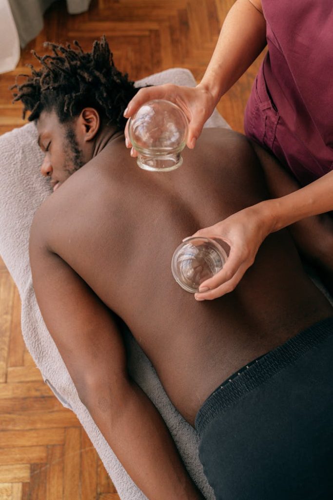 Man receiving traditional cupping therapy for relaxation and muscle tension relief.